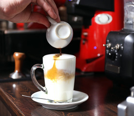 Barista making latte using coffee machine