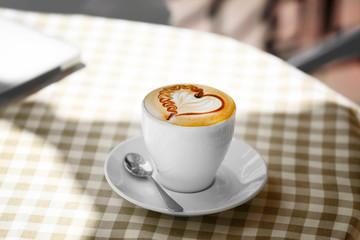 Cup of coffee with heart shape foam