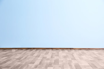 Fototapeta premium Empty room with blue wall and wooden floor