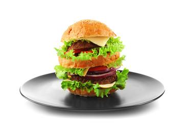Double hamburger on a black plate isolated on white