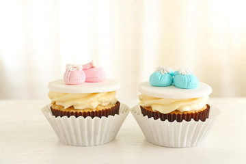 Delicious cupcakes on light background