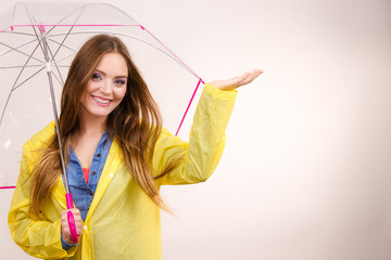 Woman in rainproof coat with umbrella. Forecasting