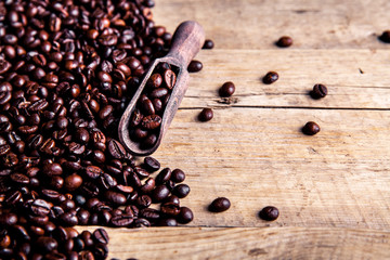 Coffee beans in wooden spoon, close up