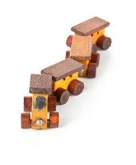 Wooden toy train with locomotive and wagons on white background