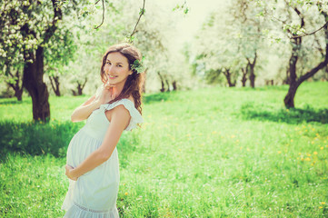 Pregnant woman in the apple orchard