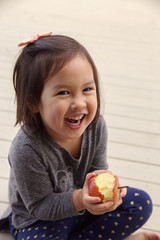 happy girl hands holding a red bitten apple,health concept