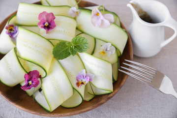 Zucchini salad with edible flowers, summer vegan salad