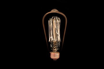 Incandescent light bulb on black background