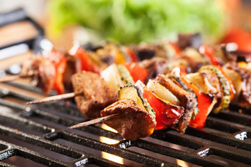 Grilling shashlik on barbecue grill
