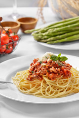italian spaghetti bolognese topped with cheese and basil