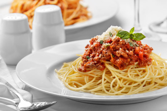 italian spaghetti bolognese topped with cheese and basil