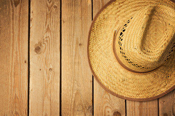 Fototapeta na wymiar Cowboy hat on wooden vintage table. View from above