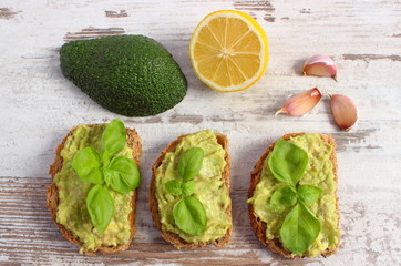 Freshly sandwiches with paste of avocado and ingredients, healthy food and nutrition