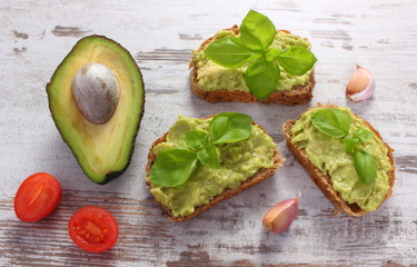 Freshly sandwiches with paste of avocado and ingredients, healthy food and nutrition