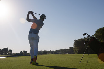 golf player hitting shot