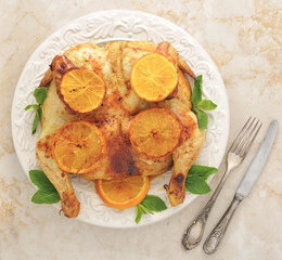 roast chicken with lemon and honey - whole chicken on a platter