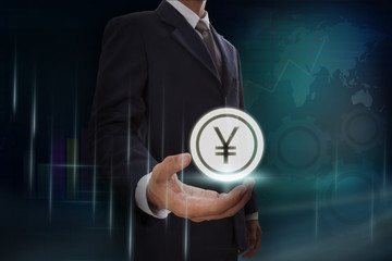 Businessman showing yen sign on screen. business concept