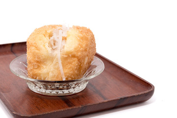 Coconut bread on wooden tray isolated on white background