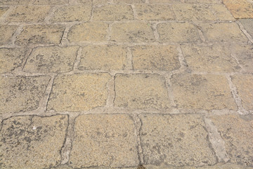 Abstract background of old cobblestone pavement close-up