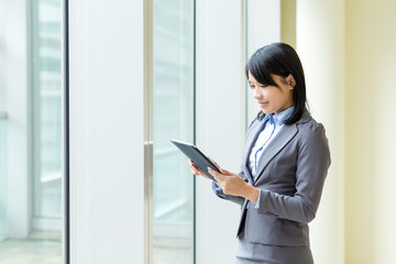 Asian business woman working on tablet pc