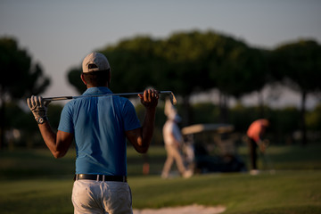 golfer from back at course looking to hole in distance