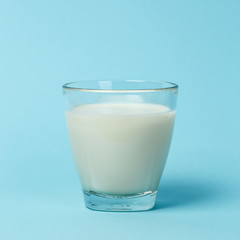 Milk glass over blue background