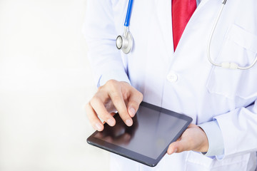 Doctor using tablet in white isolated background