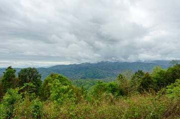 Obraz premium Top view of naturel mountains landscape with black rain clouds in the rainy season