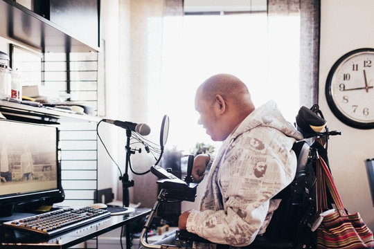 Side view of disabled musician in recording studio