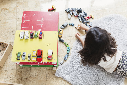 High angle view of girl playing with toy car in day care center