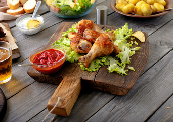 Grilled chicken legs on lettuce leaves