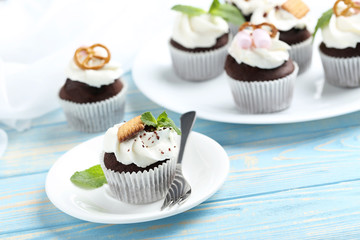 Chocolate cupcakes on a blue wooden table