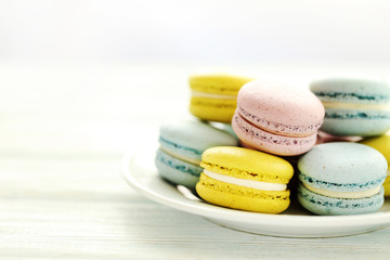 French colorful macarons on a white wooden table