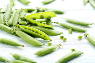 Green peas on a blue wooden table