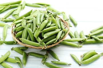Green peas on a blue wooden table