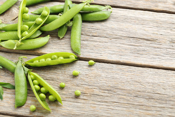 Green peas on a grey wooden table