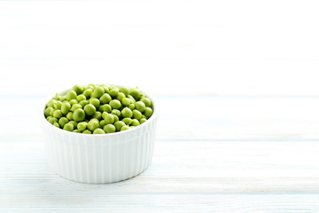 Green peas on a blue wooden table