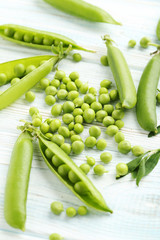 Green peas on a blue wooden table
