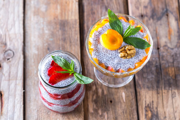 Raw vegan dessert: Chia seeds pudding with fruits on a wooden background 