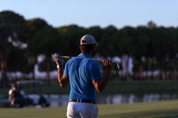 golfer from back at course looking to hole in distance