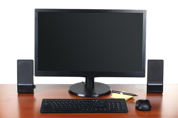Fototapeta premium monitor with accessories and office items on a wooden table isolated on white background