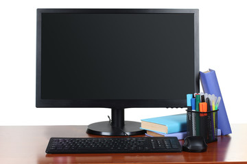 monitor with accessories and office items on a wooden table isolated on white background