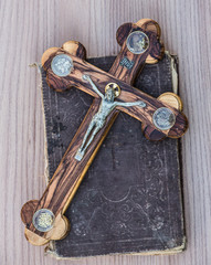 a wooden crucifix and the Gospel