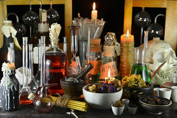 Mystic witch laboratory with candles and herbs