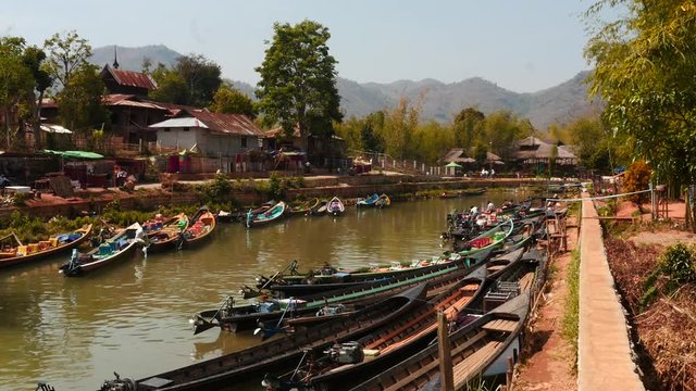 Jetty in Burmese Nyaungshwe  at Inle lake with people and boat motion time laps