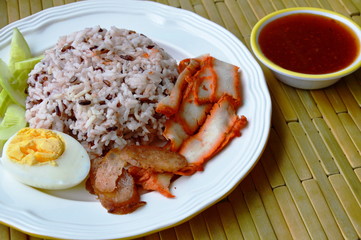 barbecued red pork on brown rice dipping sweet sauce