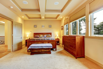 Luxurious big bedroom with wooden bed, vanity cabinet, trimmed c
