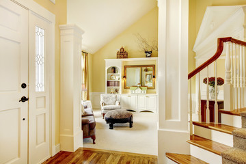 Golden and white golden hallway with beige carpet, columns and s