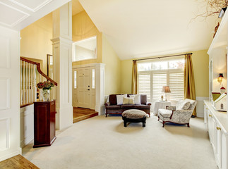 Luxury home well decorated golden living room with beige carpet.