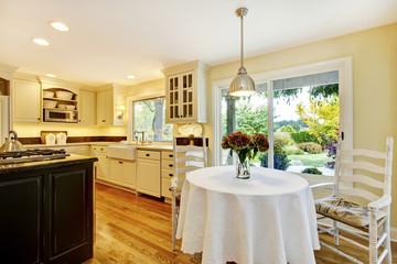 Dining table with classic kitchen interior with large window.